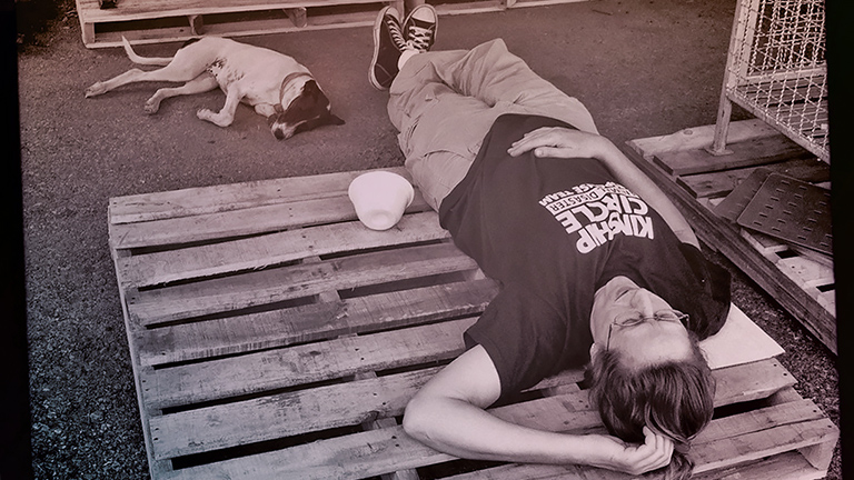 Beth Schmidt and rescued dog take nap, (c) Kinship Circle